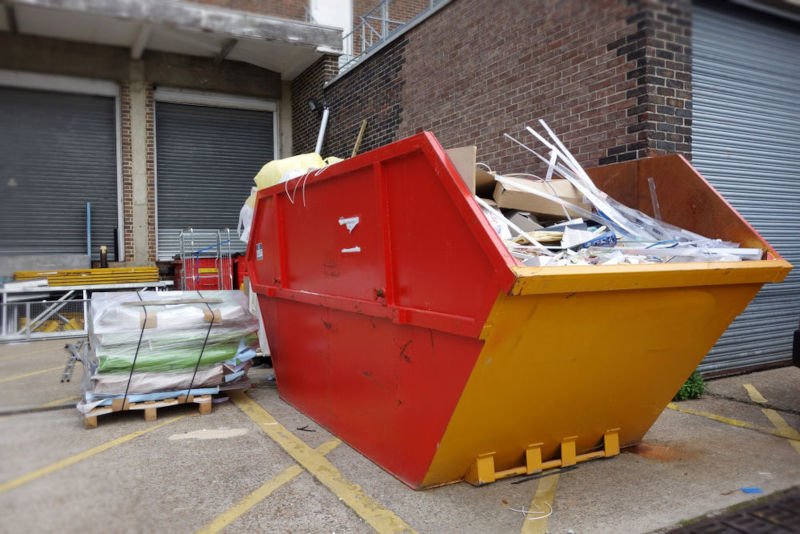 Image of a red and yellow skip container